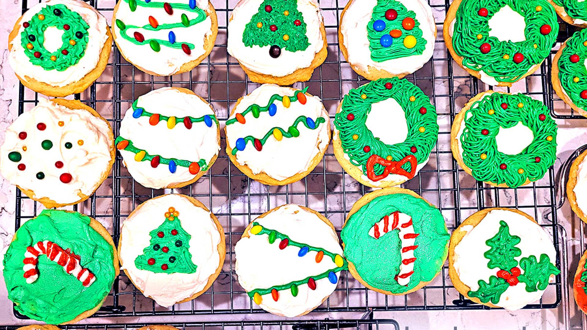 Drop Sugar Cookies decorated and resting on a cooling rack.