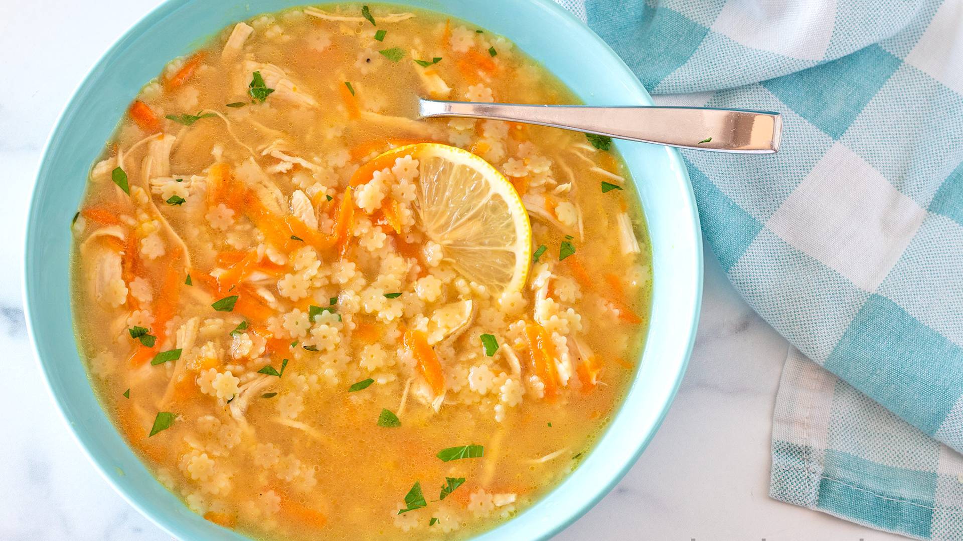Chicken Pastina Soup in a turquoise bowl.