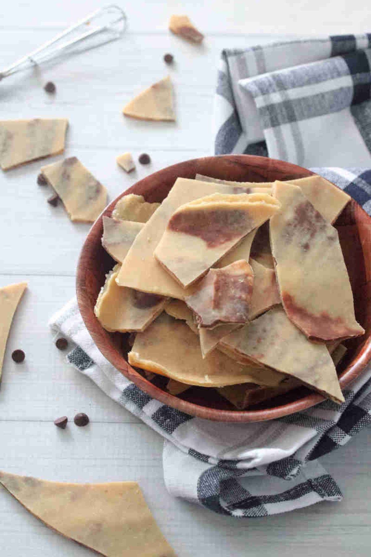 Peanut butter and chocolate protein bark in a wooden bowl.