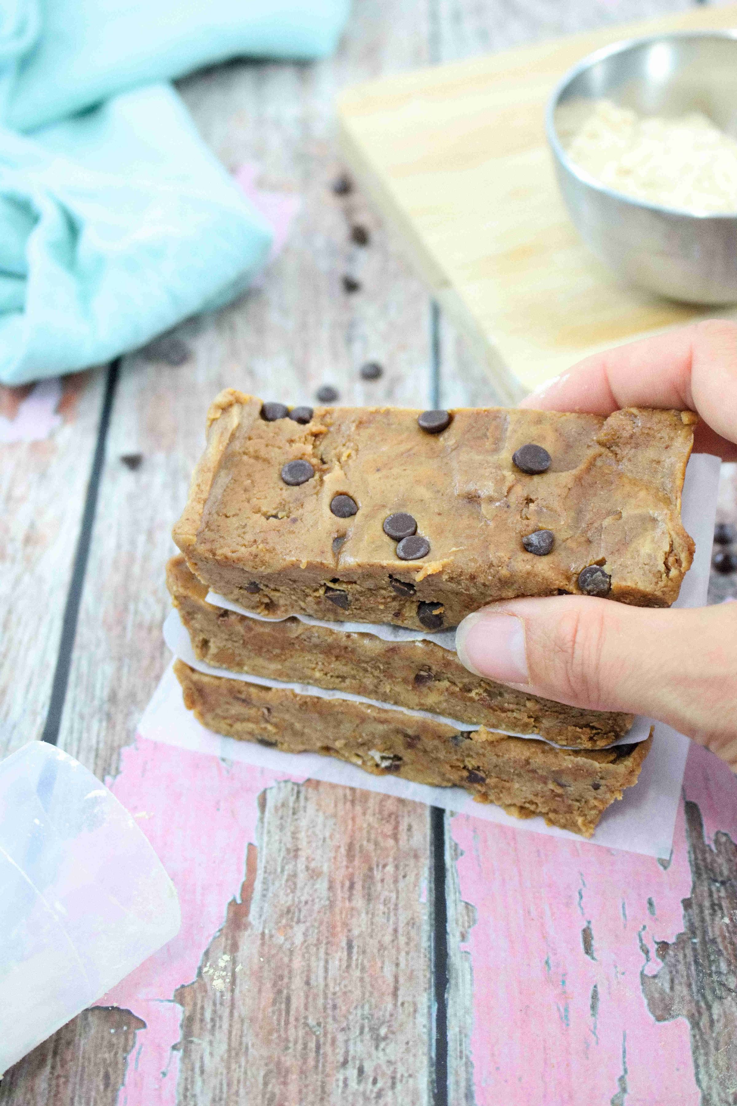 Cookie dough protein bars being stacked.
