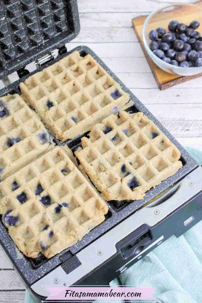 Blueberry waffles in a cast iron waffle maker.
