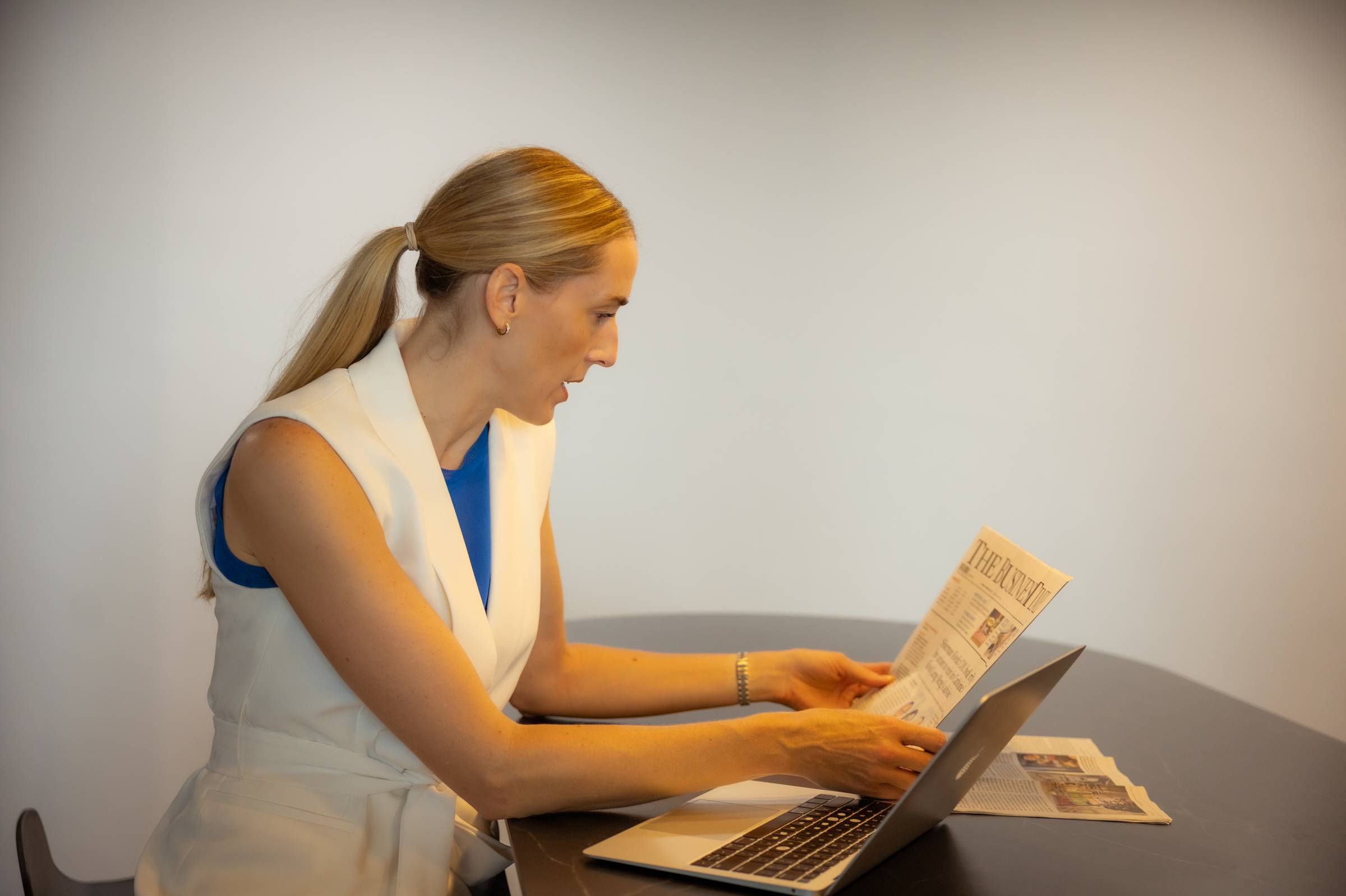 Woman reading a document at her laptop.