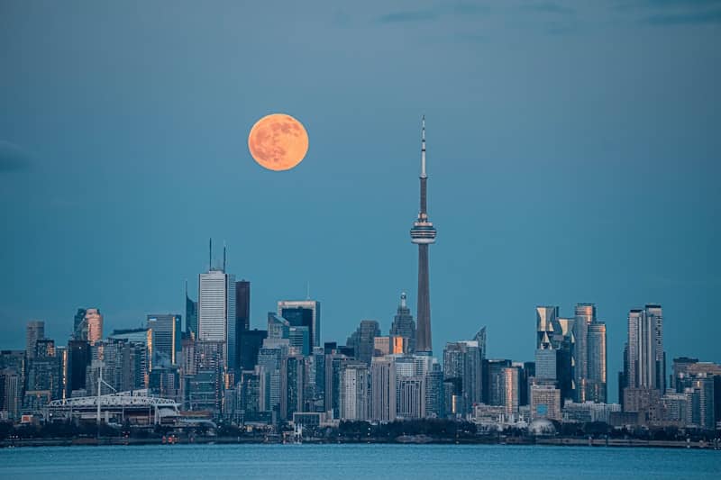 city skyline under full moon