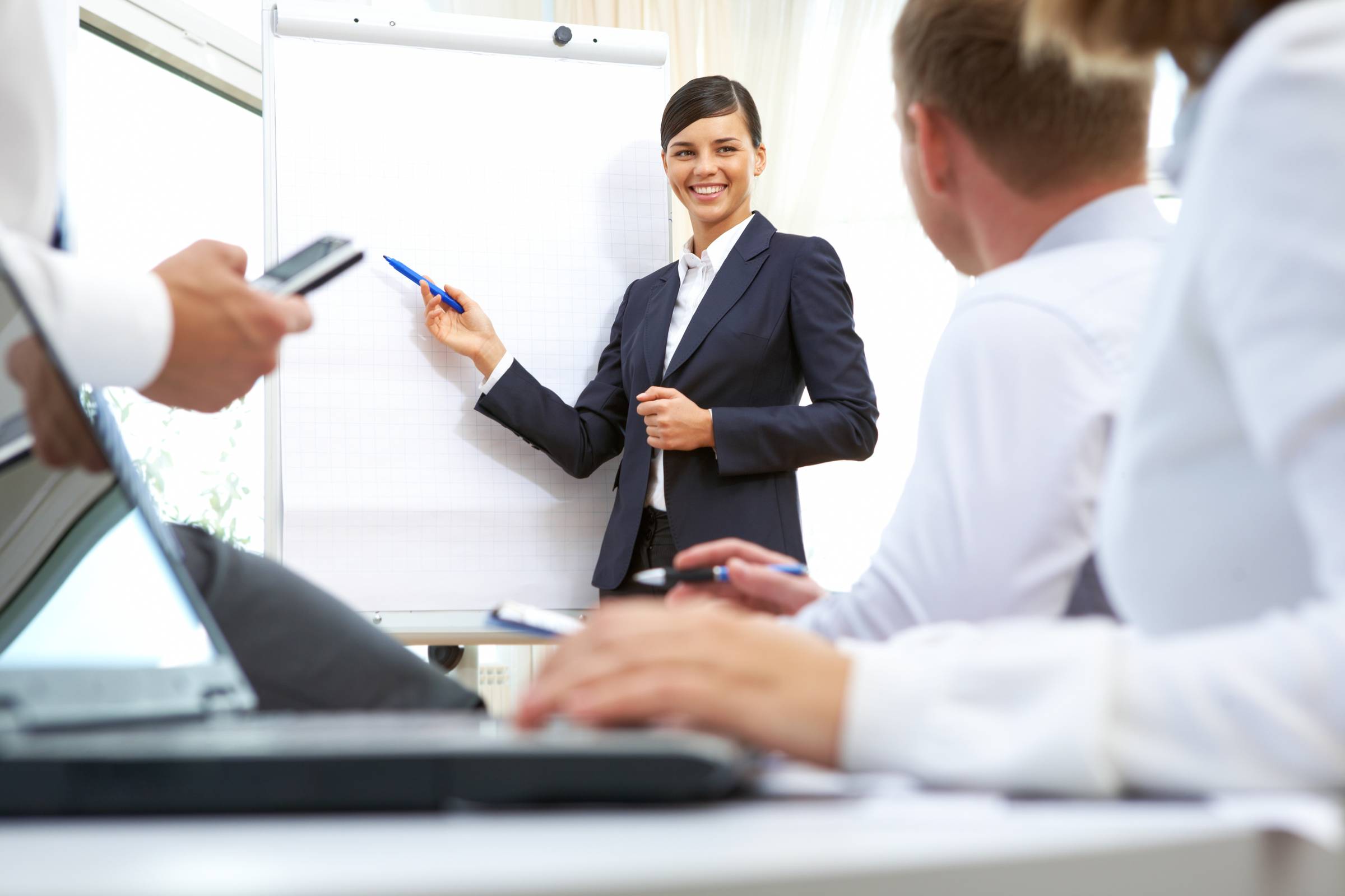 woman in green jacket raising her hands