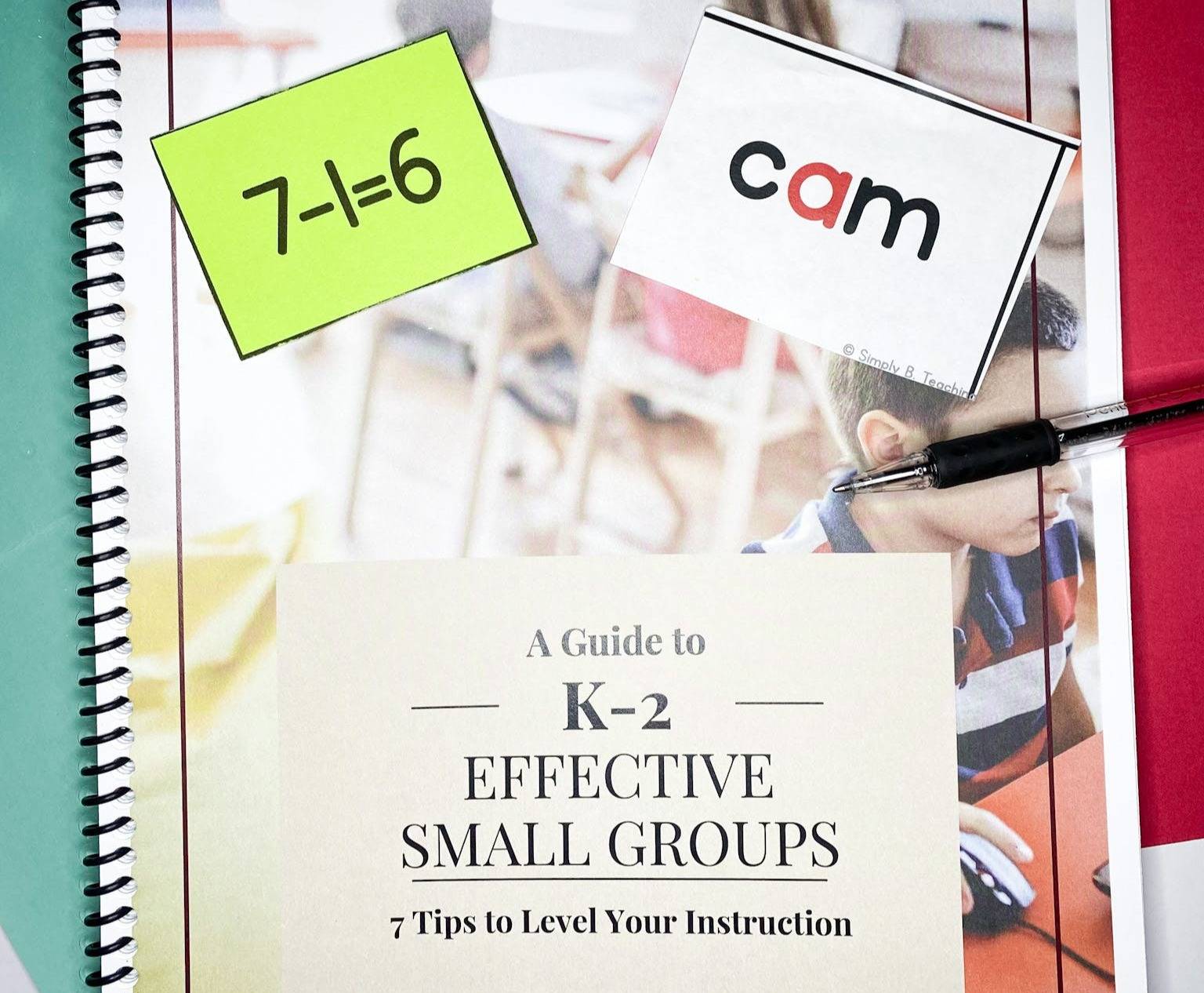 A guide to k-2 effective small groups sits on red and green paper