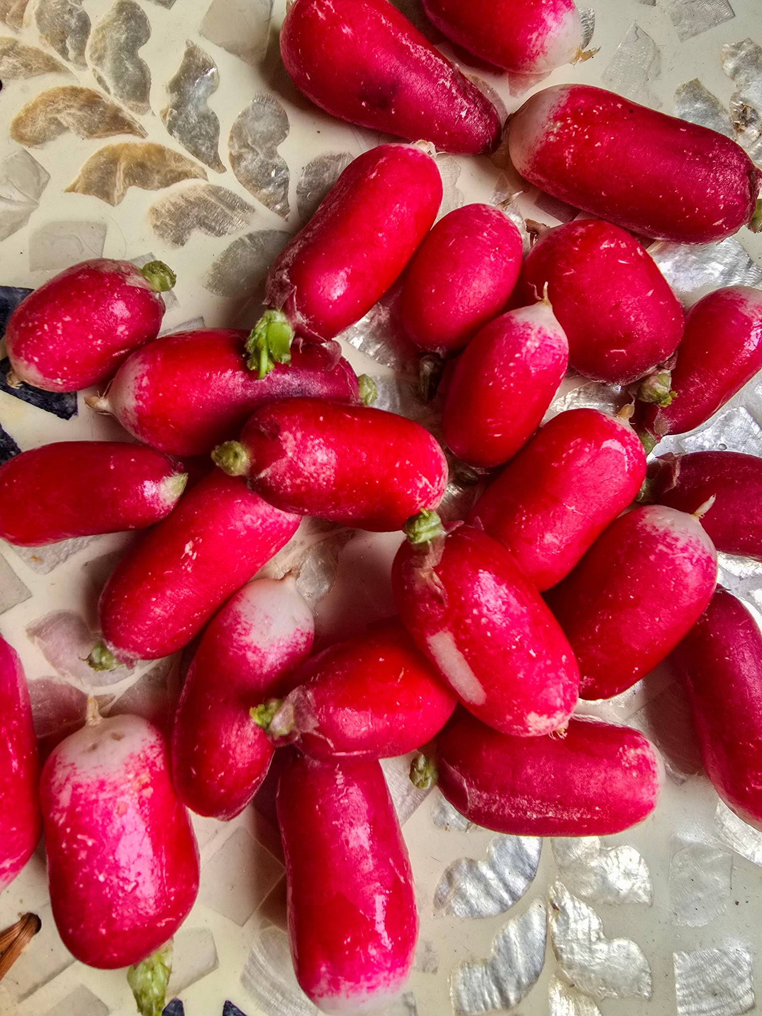 A bunch of fresh radishes on a platter