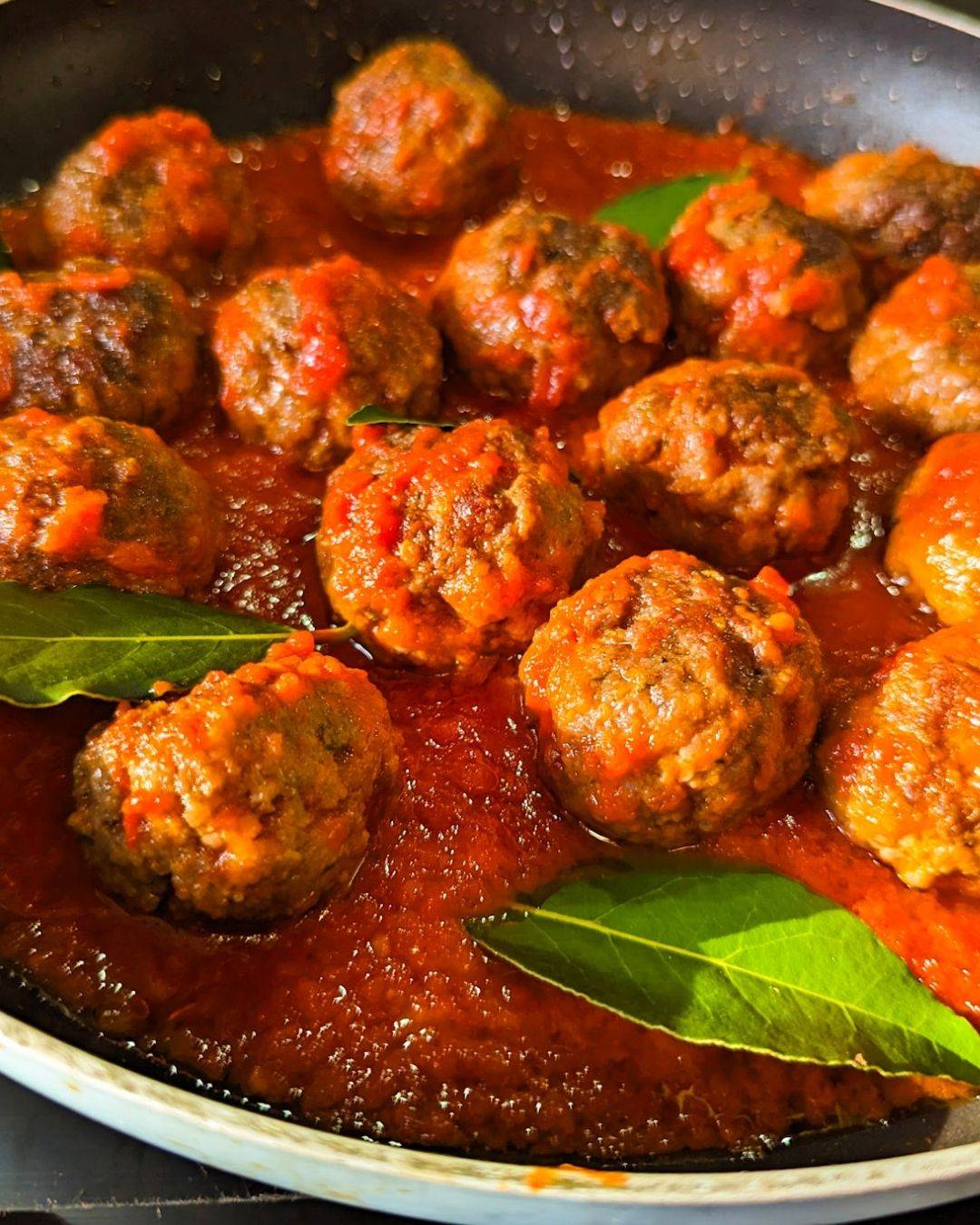 Meatballs with wagyu ground beef in a smooth tomato sauce with fresh bay leaves.