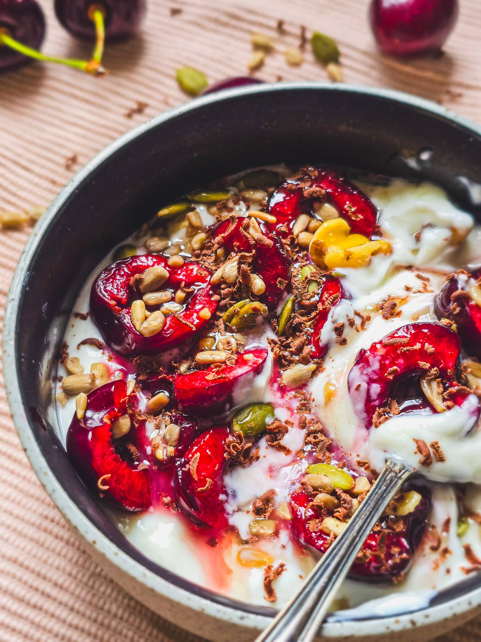 A cherry chocolate skyr bowl with nuts, seeds and honey.