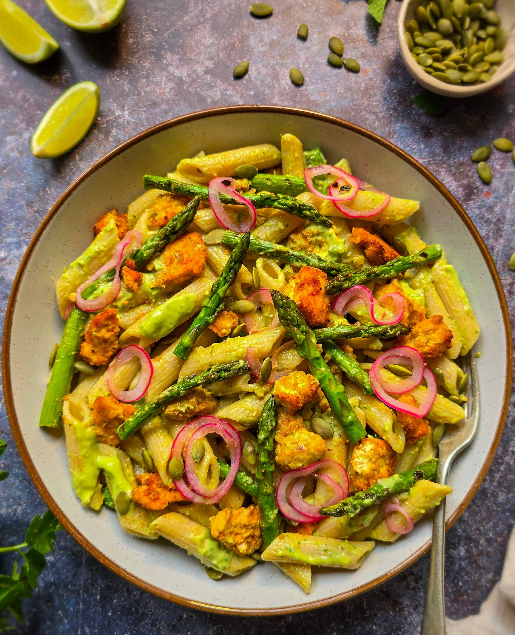 A creamy asparagus pasta salad with crispy tofu and avocado lime dressing.