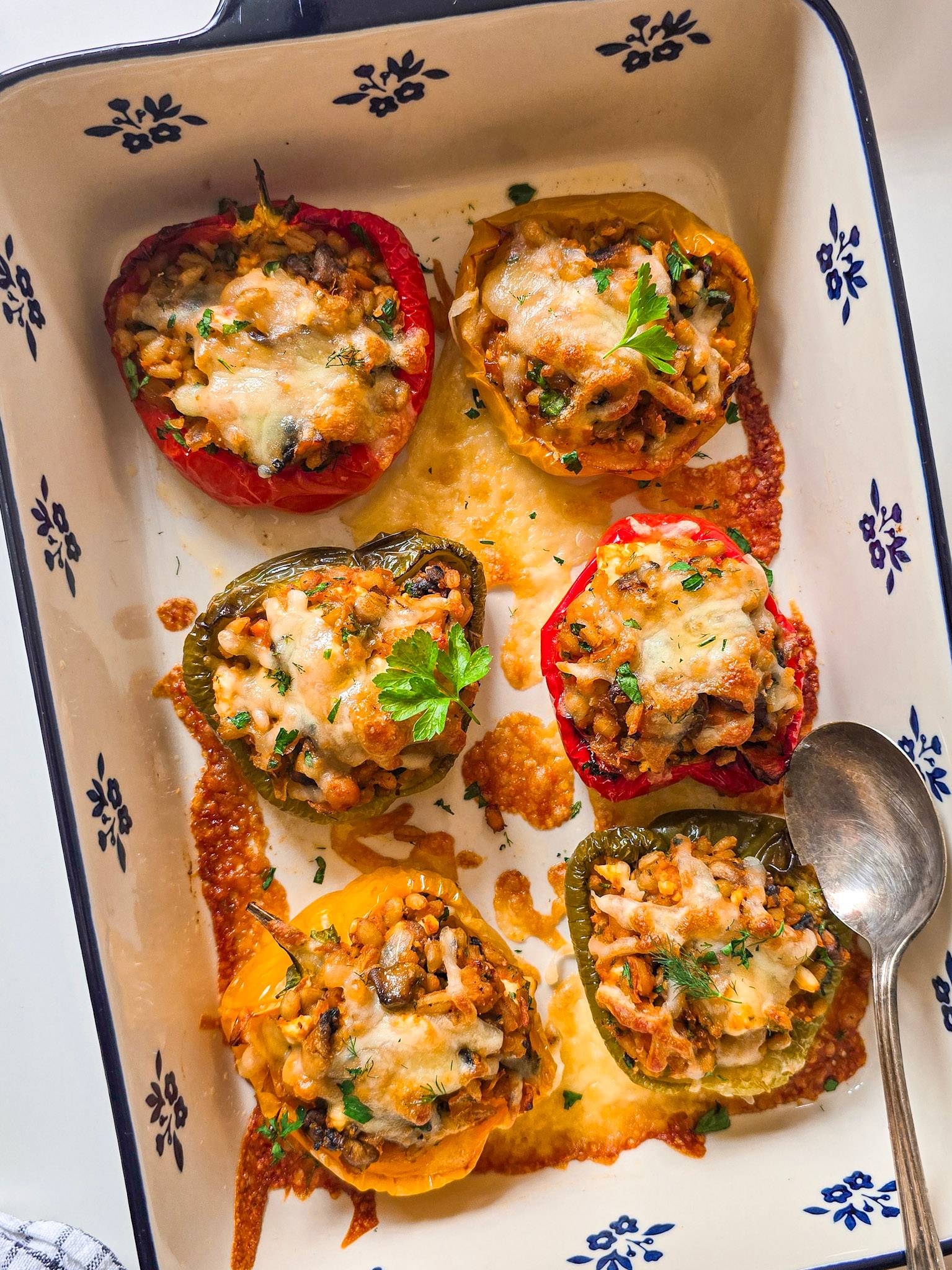 Barley stuffed peppers with mushrooms, chickpeas, and feta, baked golden