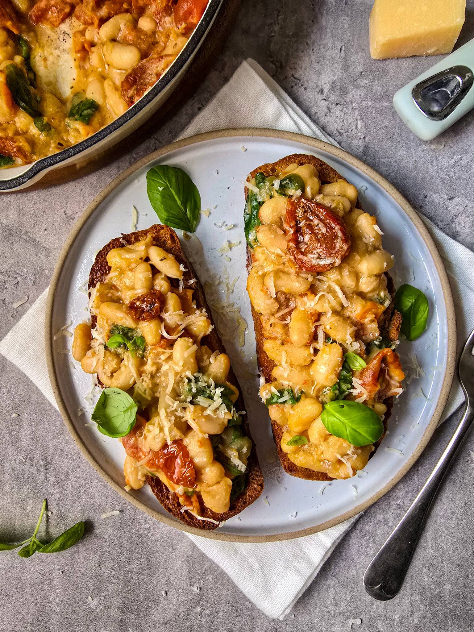 Miso Beans on Toast with Spinach, Sundried Tomatoes, basil and Parmesan.