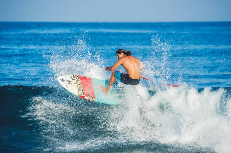 Surfer riding a wave, kicking up water