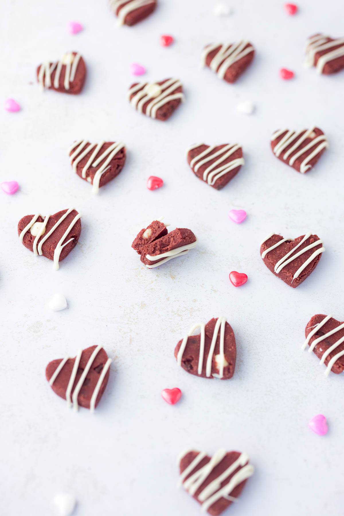 red velvet protein cookie dough hearts on white surface