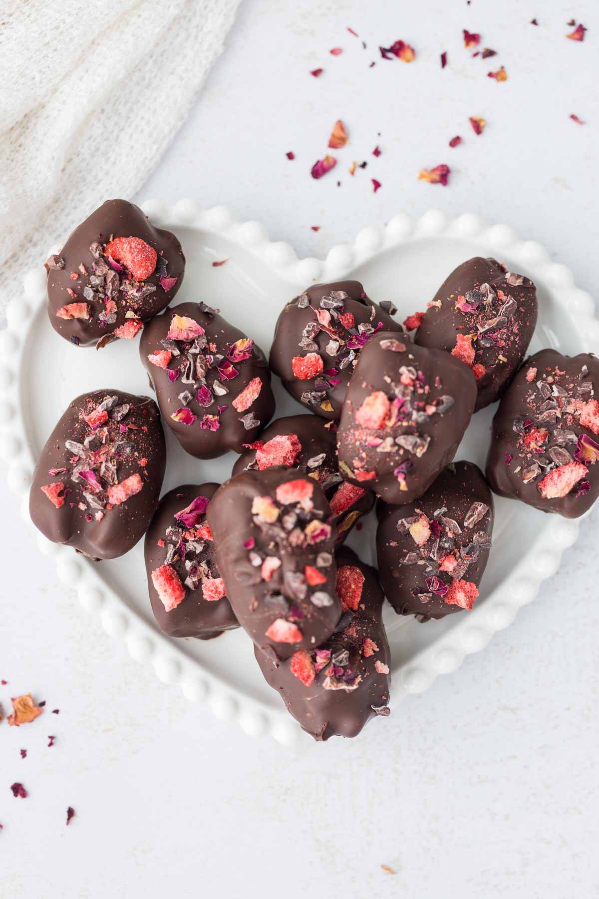 strawberry stuffed dates on white heart plate 