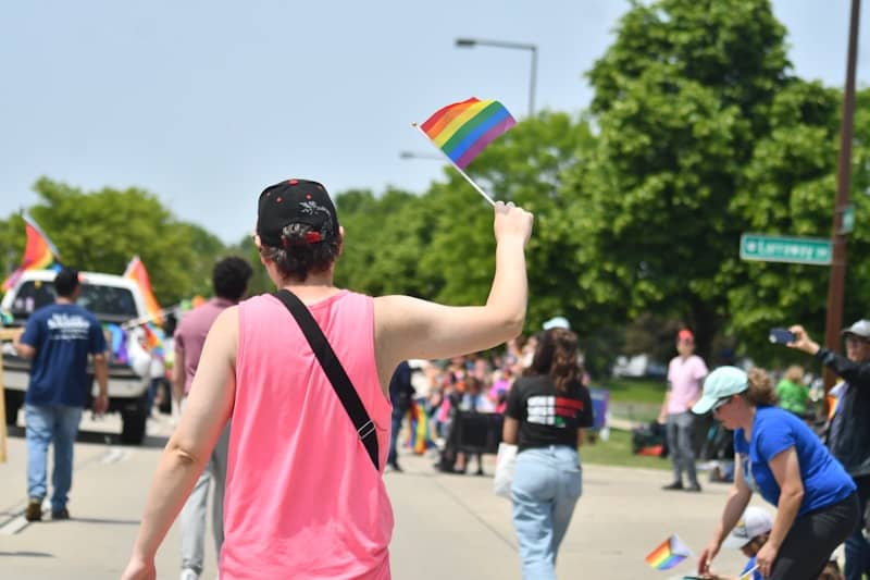 People celebrate pride with flags and joy.