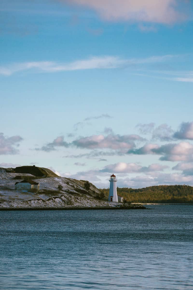 White lighthouse on a rocky island by the sea