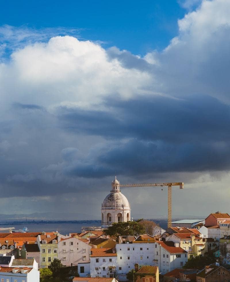 A colorful cityscape under a dramatic sky.