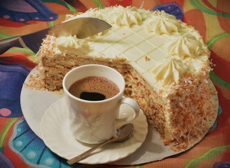 A slice of cake with a cup of coffee