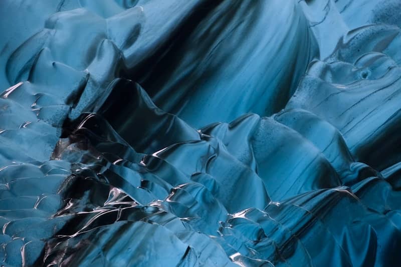 Abstract blue ice formations create a textured pattern.