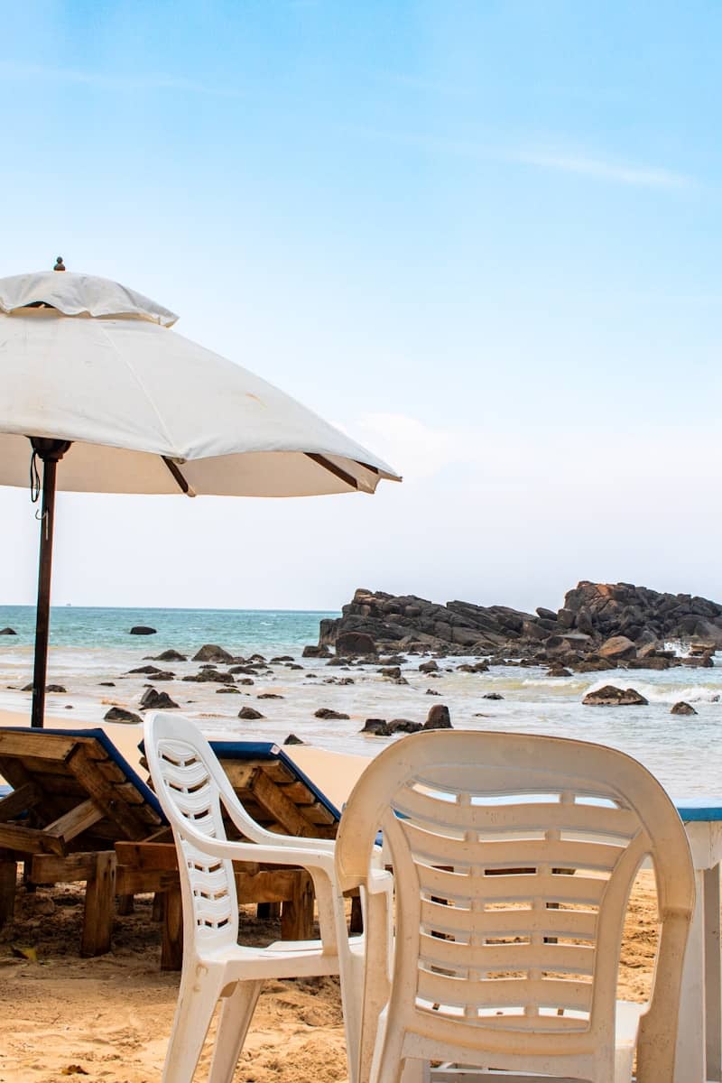 Chairs and umbrellas await on the beach.