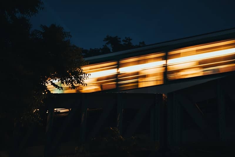 A train speeds by at night.