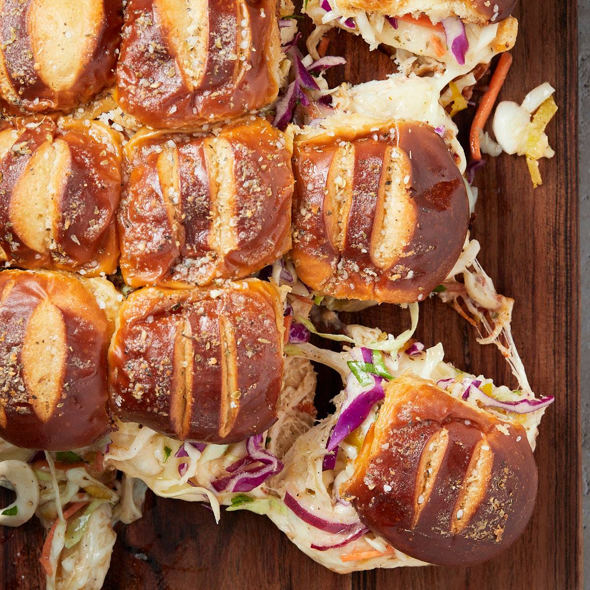 Cheesy chicken salad sliders topped with herby slaw and toasted garlic butter buns. 
