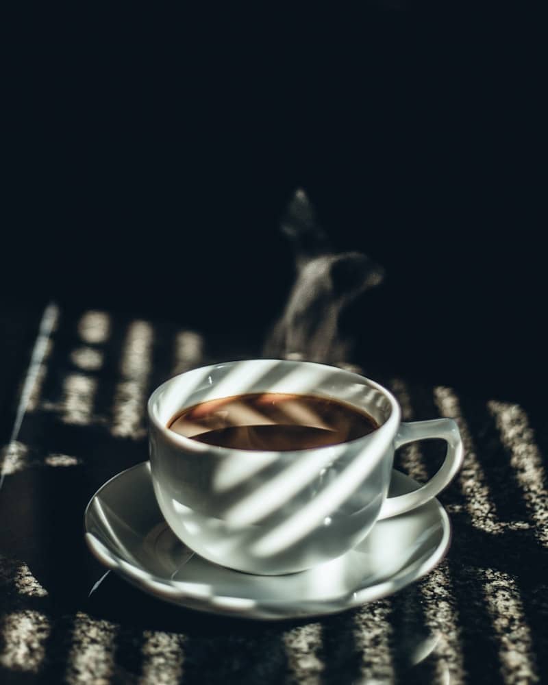 white teacup filled with tea