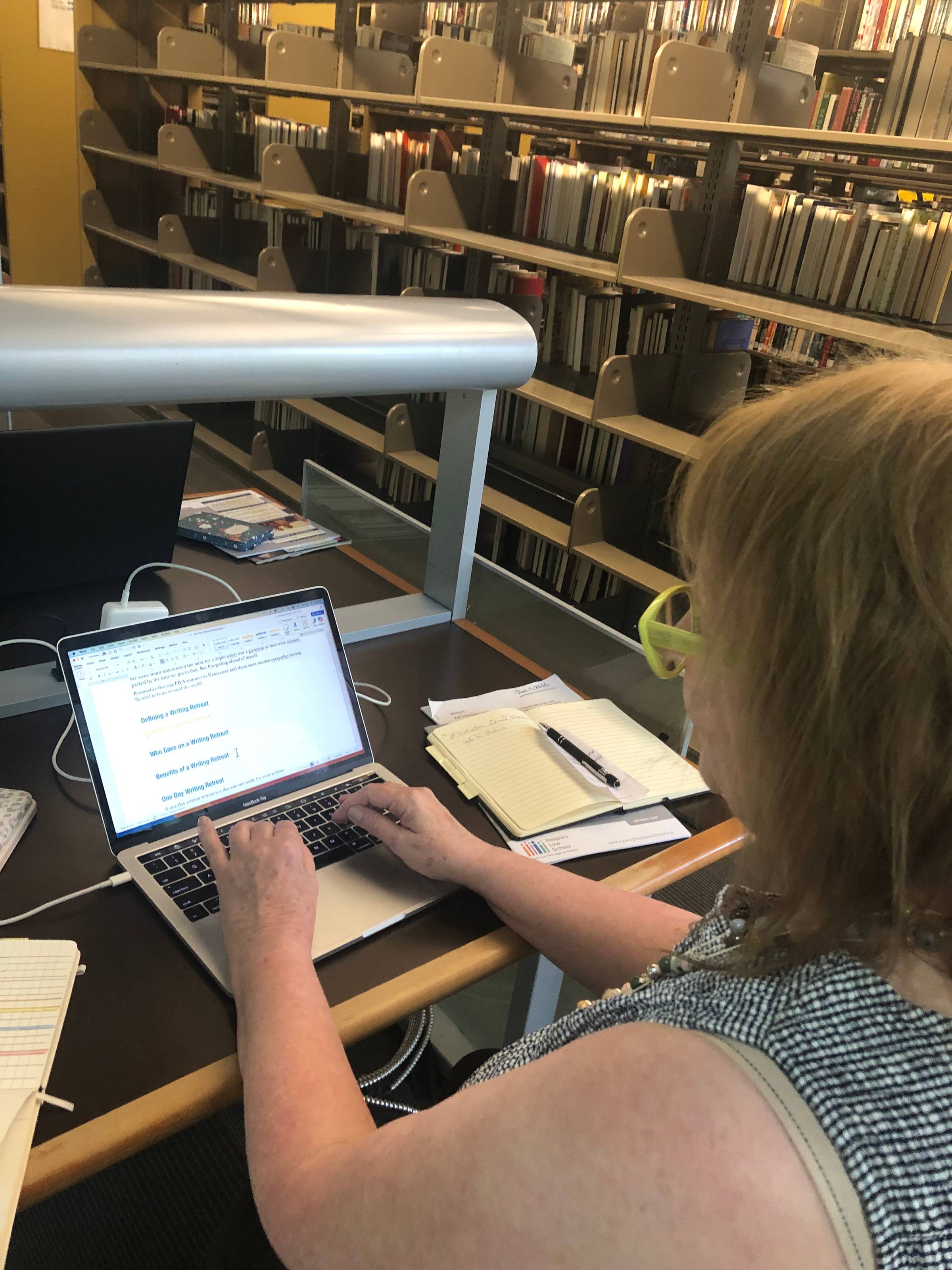 Alison writing in the library