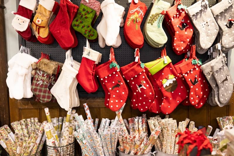 A display of christmas stockings and stocking hanging on a wall