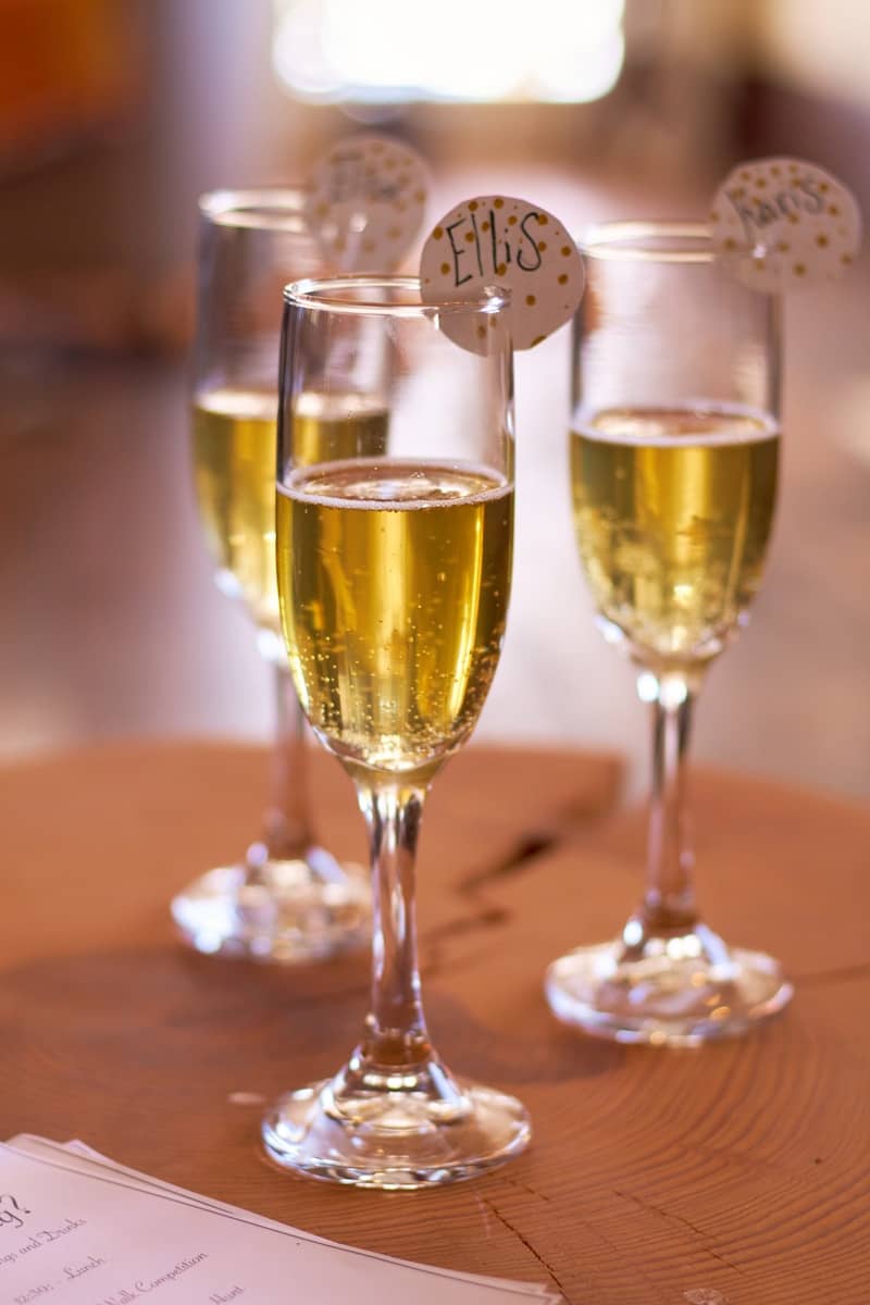 Three glasses of wine sitting on top of a wooden table