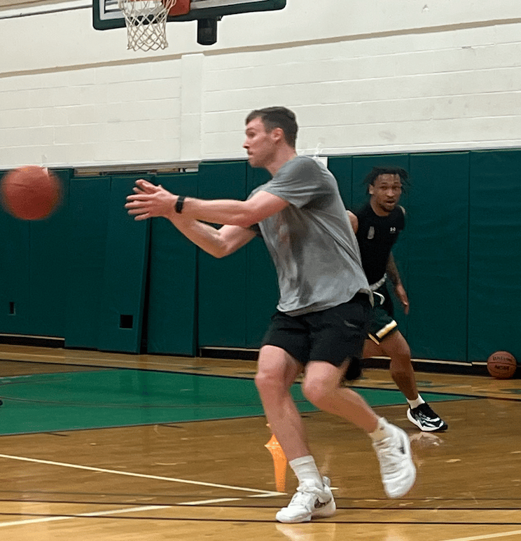 Tucker receiving pass from Coach Ryan