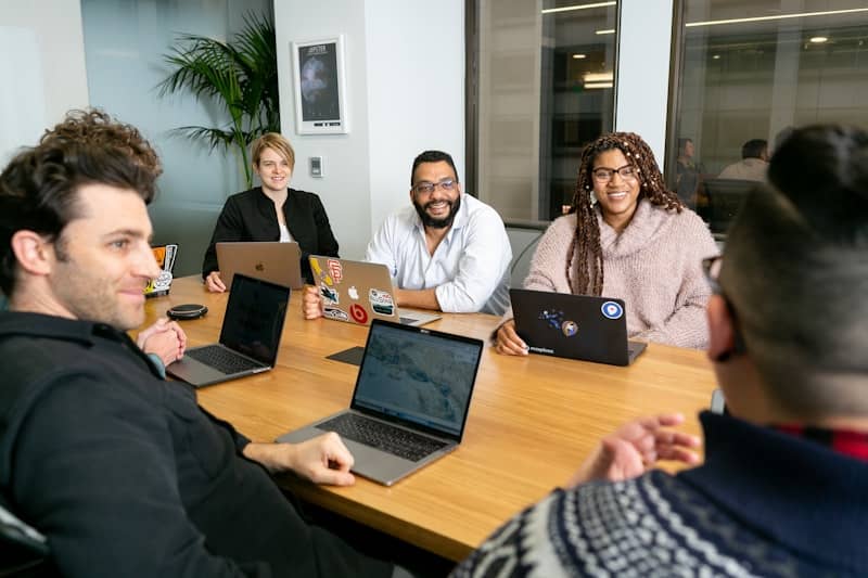 group of people sitting around a conference table in a meeting