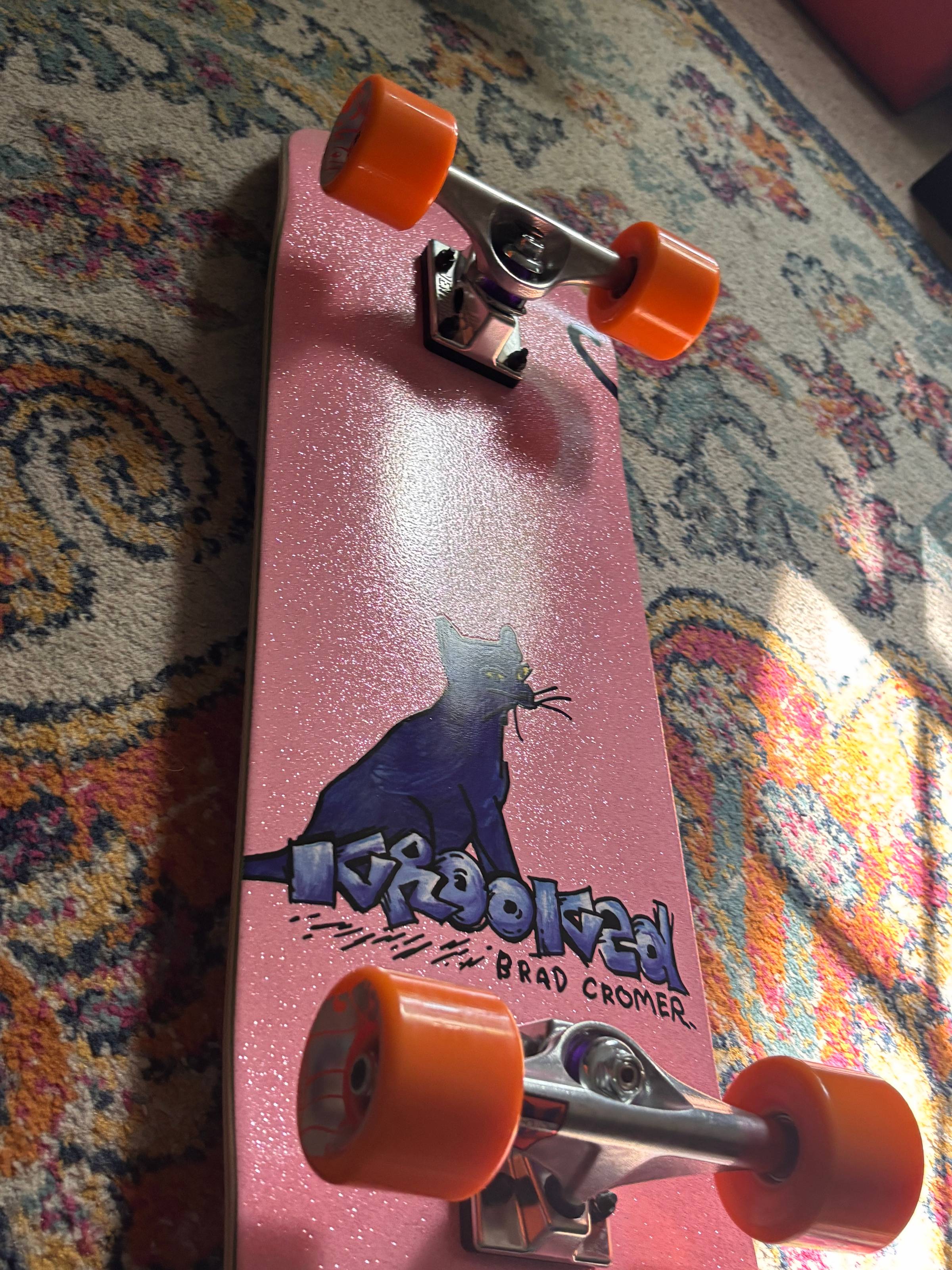 a pink glittery skateboard from Krooked