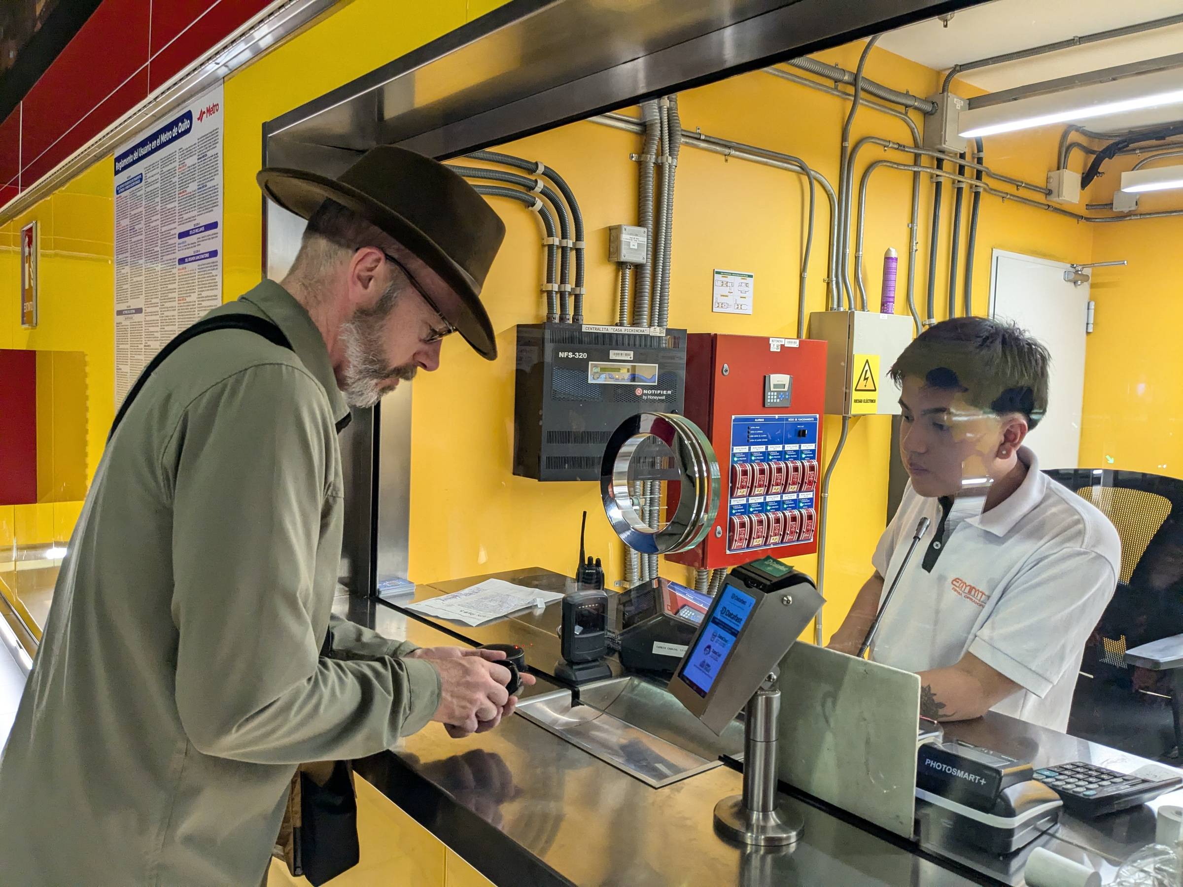 Image: Scott purchasing a ticket for Quito's Metro system.