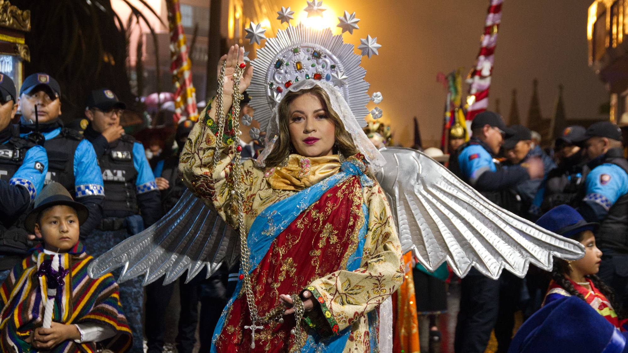 A woman portraying the Virgin of Quito wears 