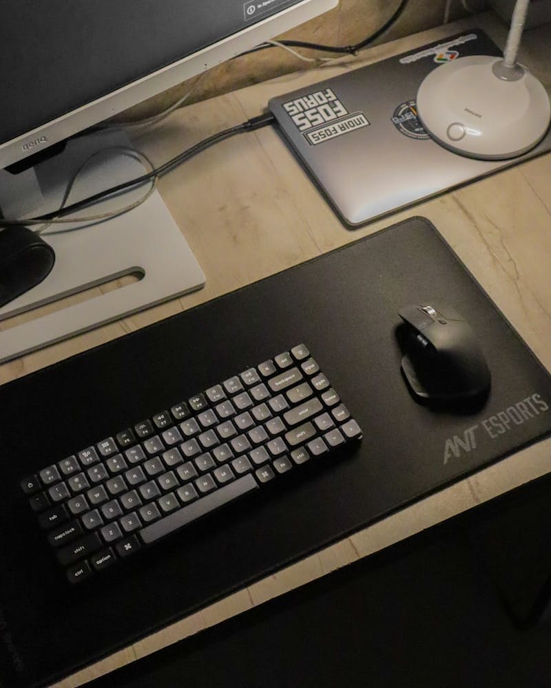 A computer desk with a keyboard, mouse and monitor