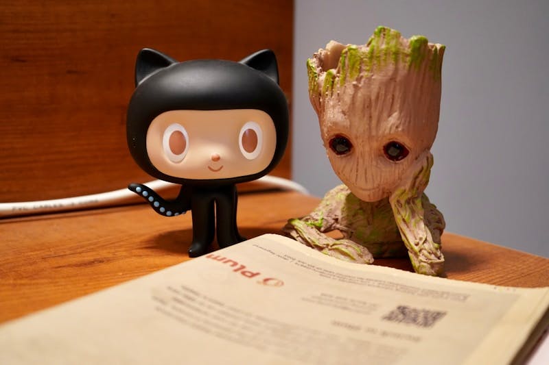 a book and a small figurine on a desk