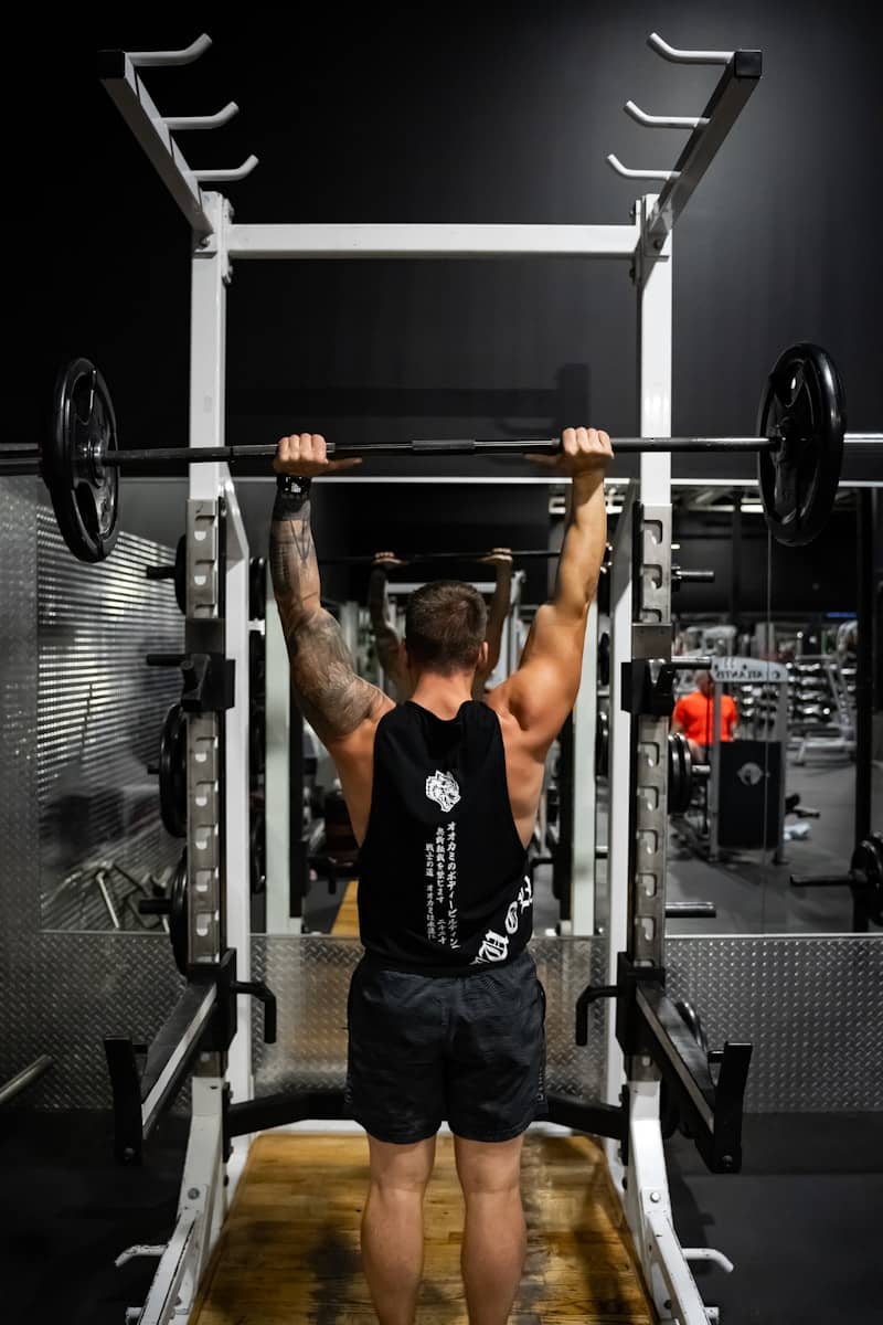 A man in a gym lifting a barbell