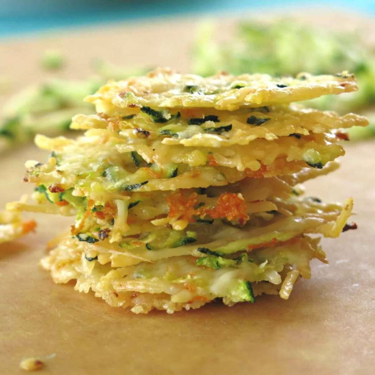 Stack of Parmesan cheese crisps on a cutting board.