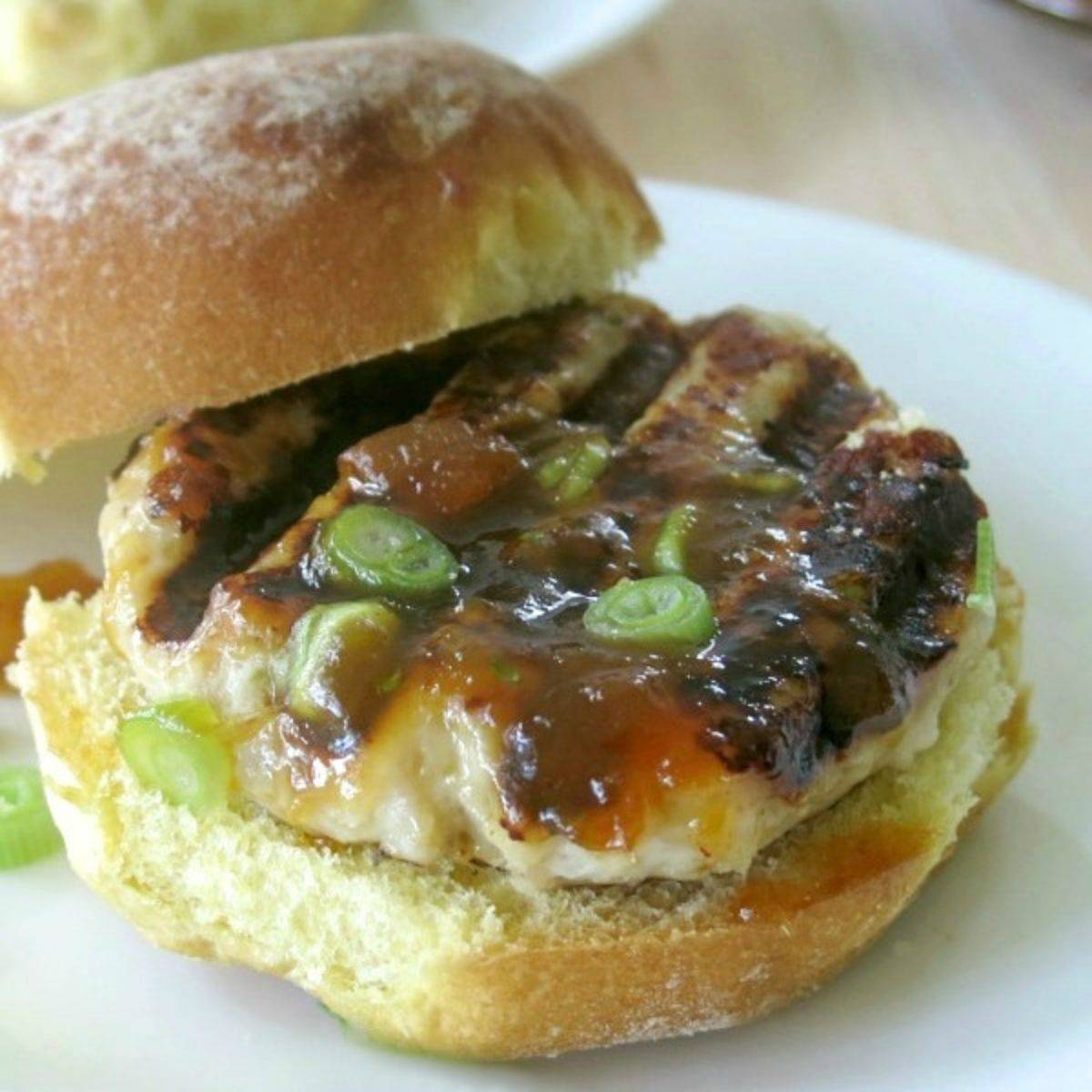 Mango turkey burger on a white plate.