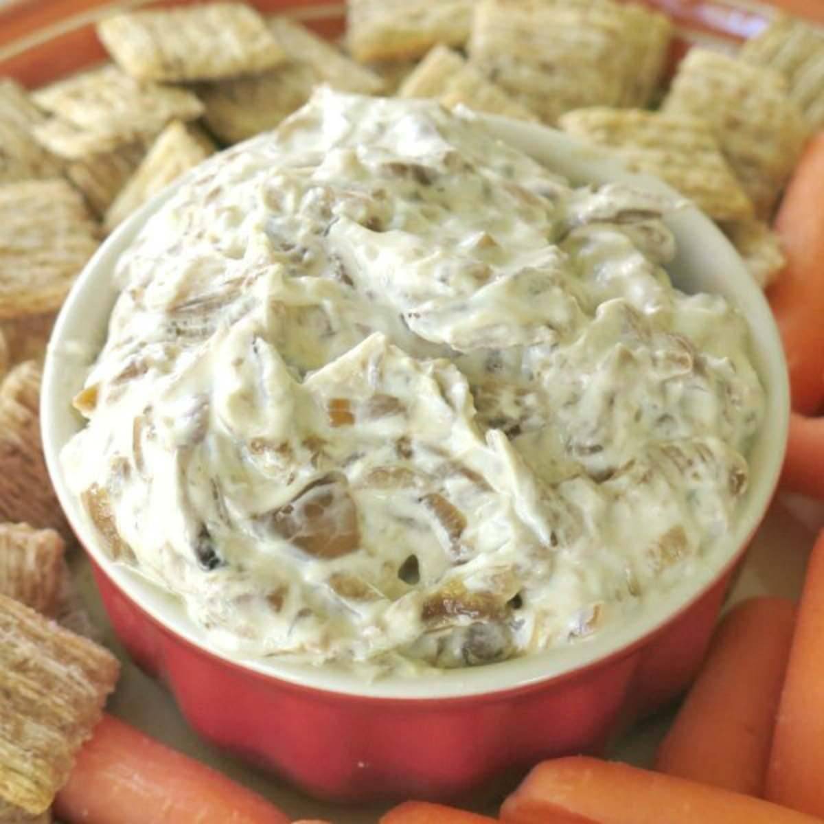 Caramelized onion dip surrounded by crackers.