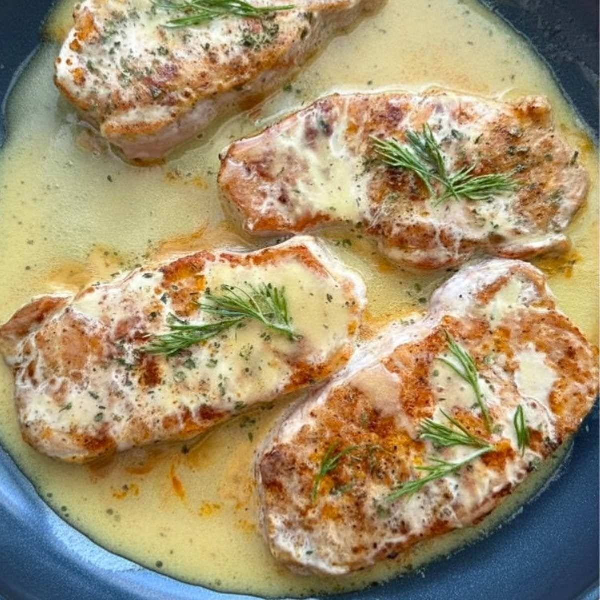 Honey mustard pork chops in a skillet.