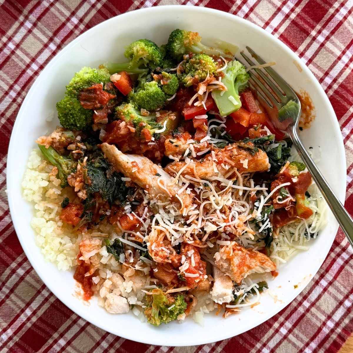 Chicken marinara meal prep bowl on a red and white napkin.