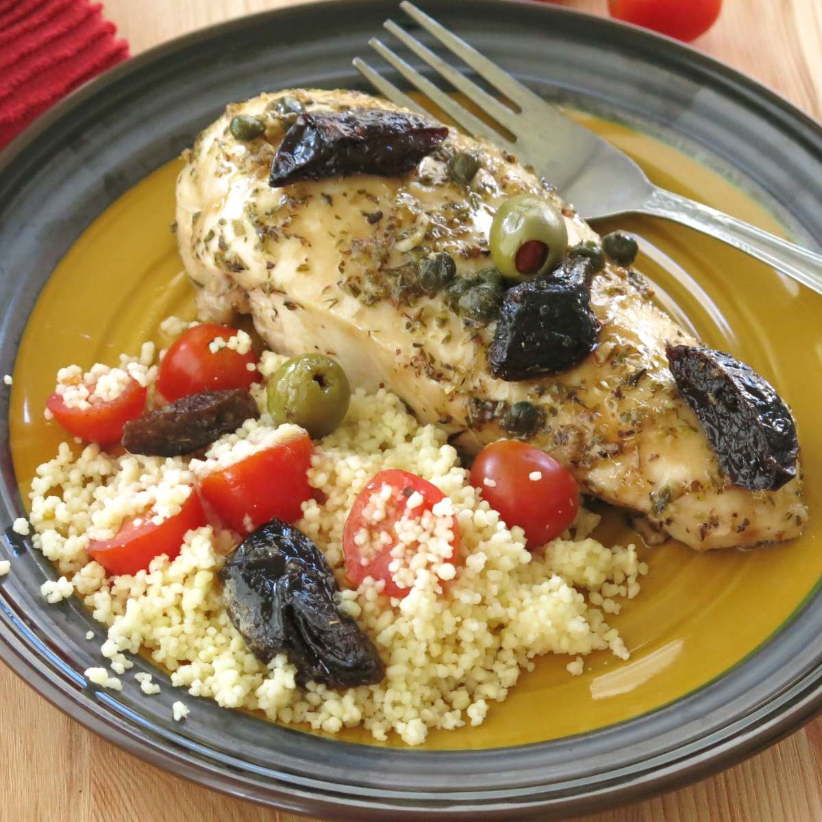 Chicken marbella on a plate.