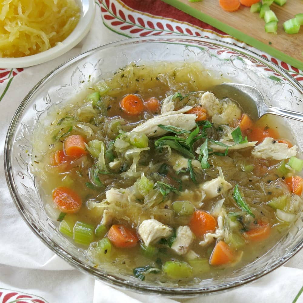 Spaghetti squash soup with chicken in a glass bowl.