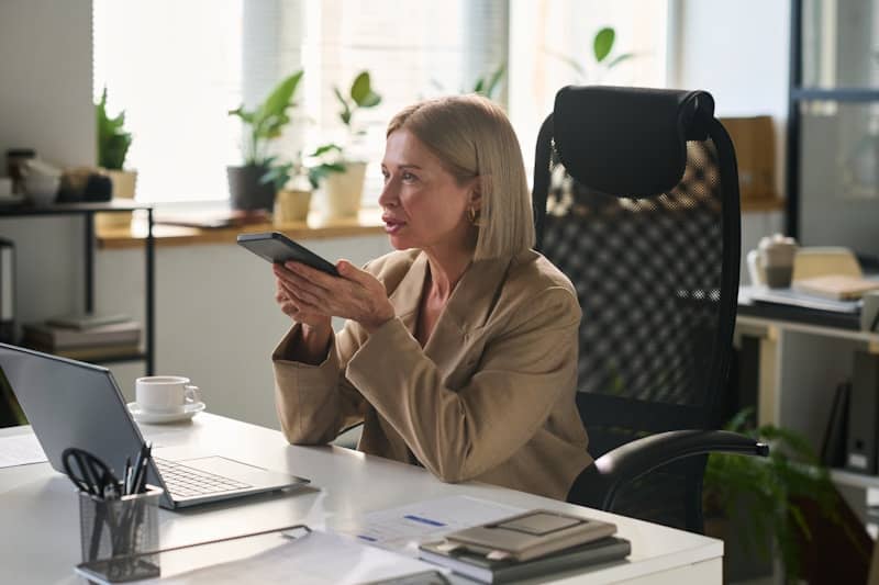 Woman uses a tablet at her office desk.