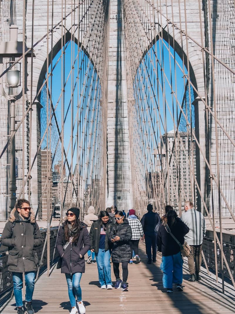 People stroll across the famous brooklyn bridge.
