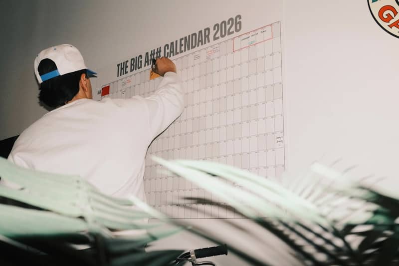 Man writing on a large 2026 calendar
