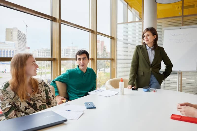 A diverse group of people in a modern meeting room.