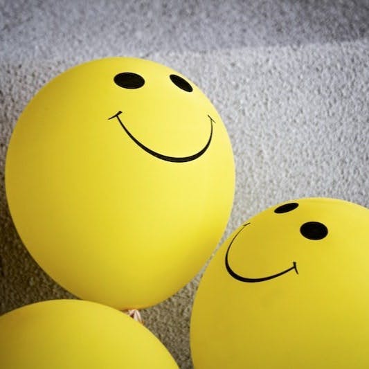 yellow smiley emoji on gray textile